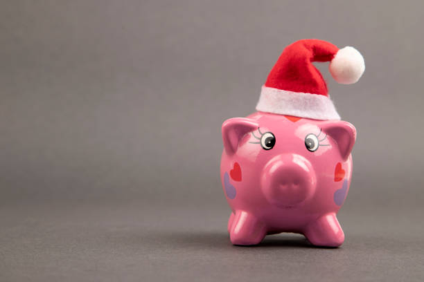 Close-Up Of Christmas Decoration And Piggy Bank On Table