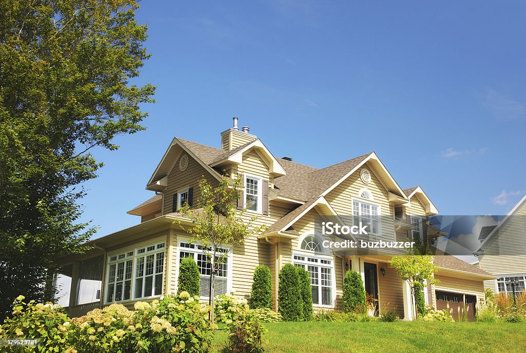 Yellow two story country house on summer day Beautiful Yellow House House Stock Photo