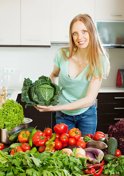 istock cheerful  woman with  vegetables and greens 179524666