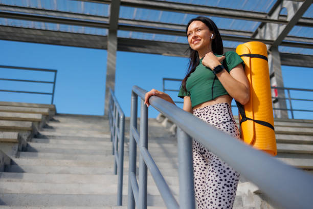 istock Fitness Passion: Young Lady with Exercise Mat Outdoors 1795257672