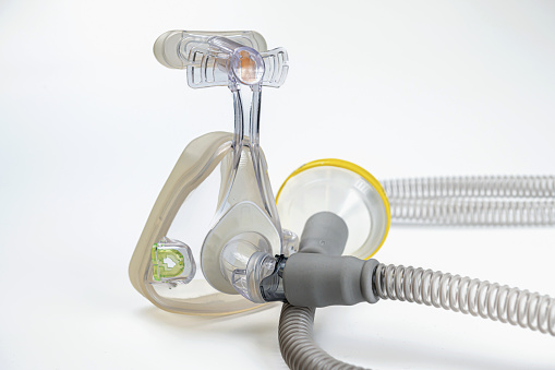 Medical device known as (CPAP) continuous positive airway pressure- mask and hose isolated on white