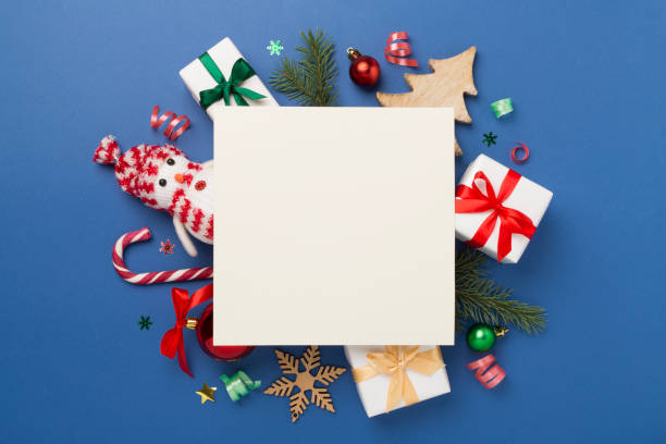 istock Greeting card mockup with christmas decor on color background, top view 1795267704