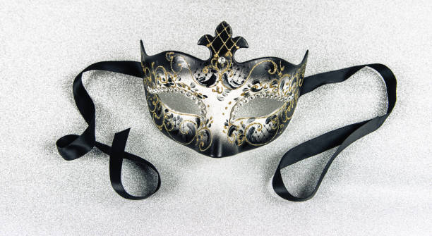 istock Carnival mask with black ribbon on silver shiny background. Close-up. 1795267707