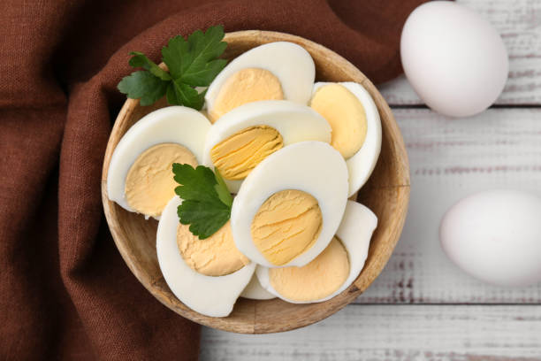 istock Fresh hard boiled eggs and parsley on white wooden table, flat lay 1795268829