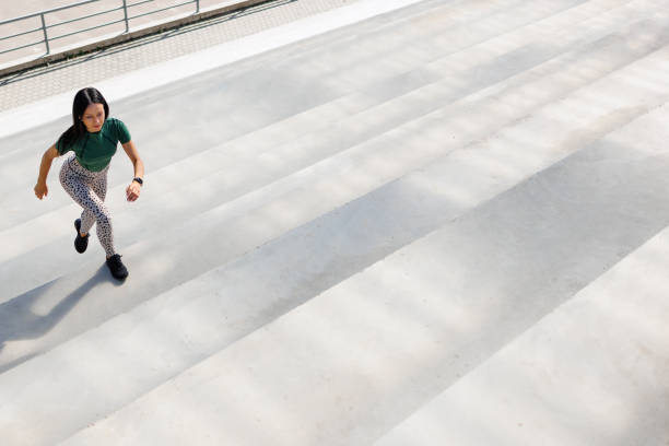 istock Athletic Woman Ascending Stadium Steps 1795270521
