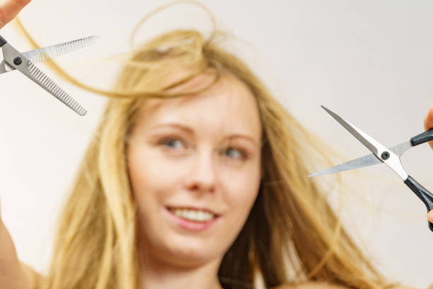 istock Young woman with scissors for haircutting 1795273253