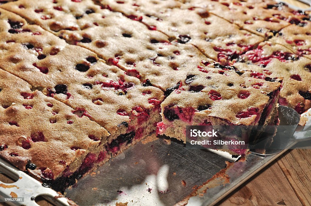 Whole-wheat black and red currant cake Whole-wheat black and red currant cake on a baking sheet,selective focus Fruitcake Stock Photo