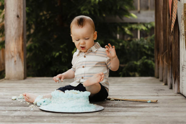 istock One Year Old Baby Boy With His Birthday Cake 1795280331