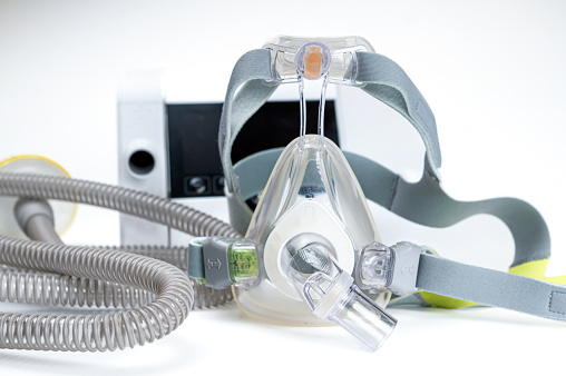 Continuous positive airway pressure system includes of CPAP machine, mask, tube on white background.