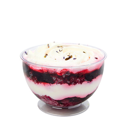 Dessert based on lavender sponge cake soaked in curd cream and juicy blueberry coffee isolated on white