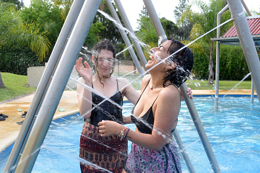 two girls having fun by the pool