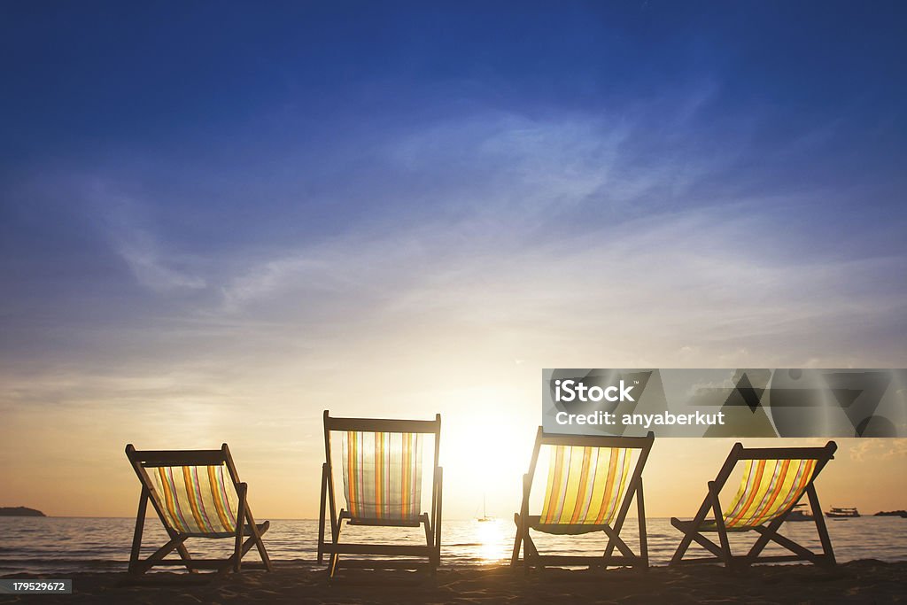 family vacations beach chairs at sunset, group tours Abstract Stock Photo