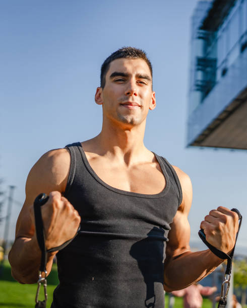 istock One man training use rubber elastic resistance band tubes outdoor 1795298890