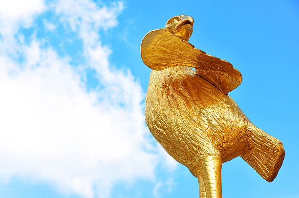 Majestic golden chicken on blue sky