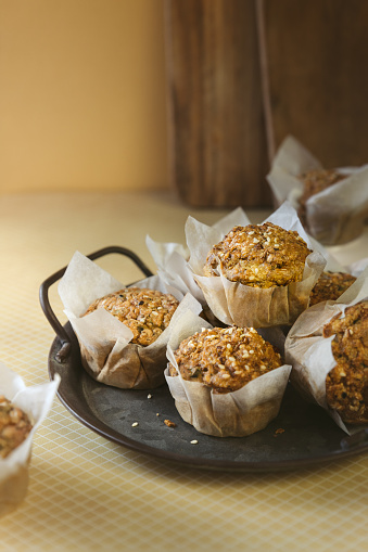 Sesame seeds savory muffins in paper cups; low carb cupcakes with leek, eggs and herbs for breakfast or afternoon snack