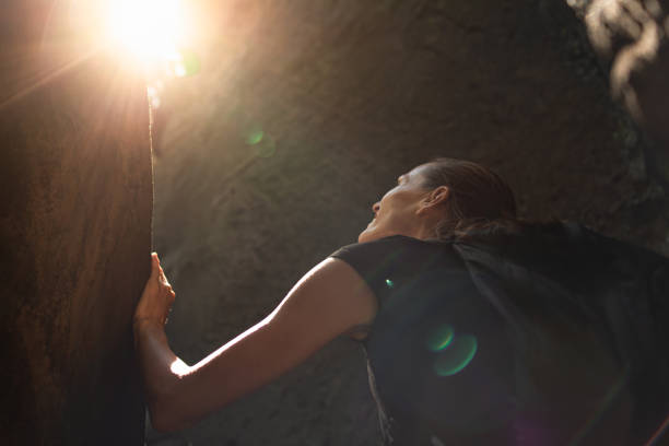 Young woman climbing rocks