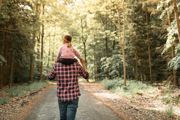istock Father and daughter walking through the forest. 1795332811
