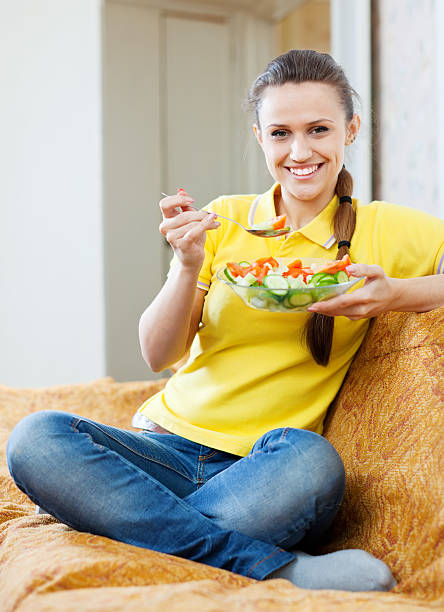 istock Pretty girl eating vegetables salad 179533718