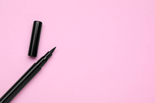 istock Eyeliner marker on pink background, top view with space for text. Makeup product 1795340767