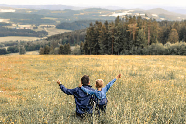 istock Happy father and son in the meadow. 1795341383