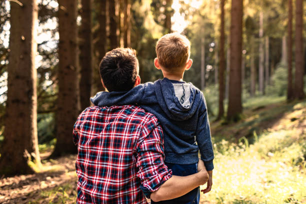 Father and son bonding together in the forest.