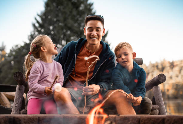 istock Father roasting marshmallows with his children. 1795352141