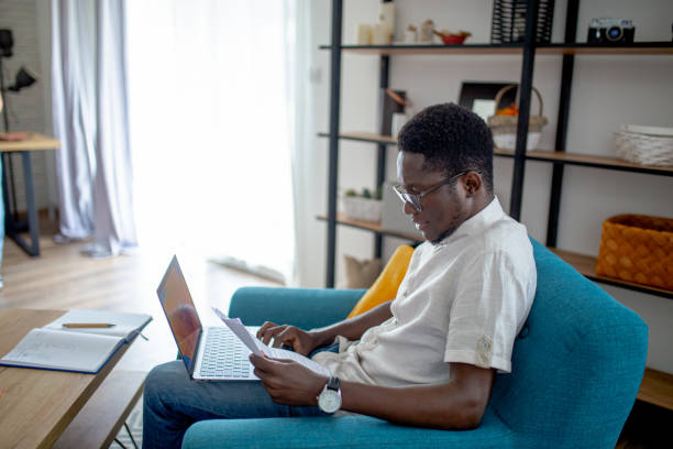 istock Young African man doing his finances at home 1795354566