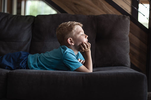 Boy relaxing on the sofa at home.