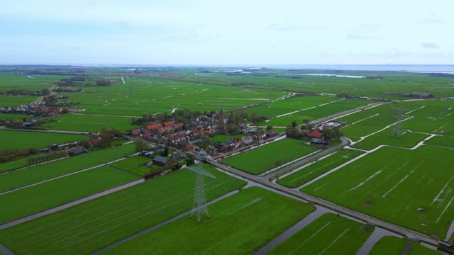 Approaching traditional Dutch village Zunderdorp in Polder by drone