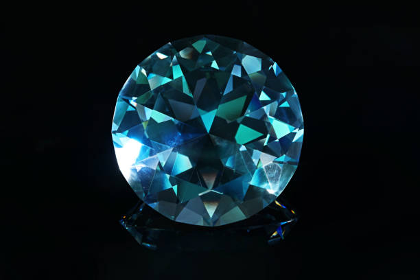 istock Beautiful dazzling diamond on black mirror background, closeup 1795361062