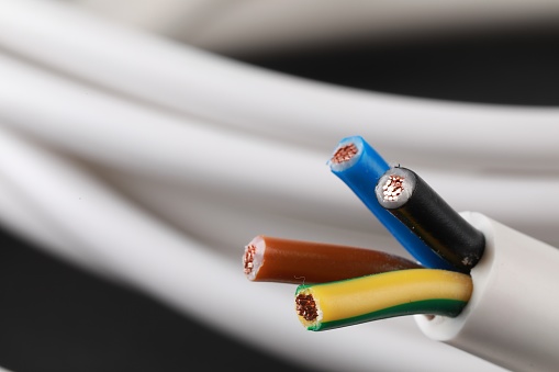 Electrical power cable isolated on blue background.