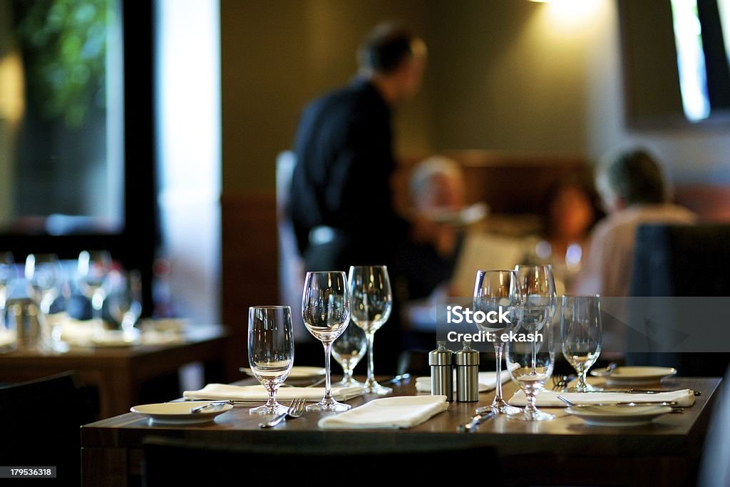 Table Setting at Restaurant A shot of beautiful table setting in gourmet restaurant Crowded Stock Photo