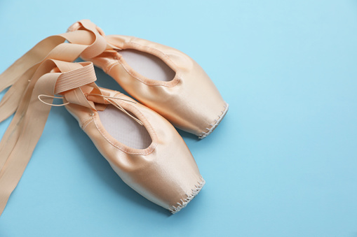 Ballet shoes. Elegant pointes on light blue background, space for text