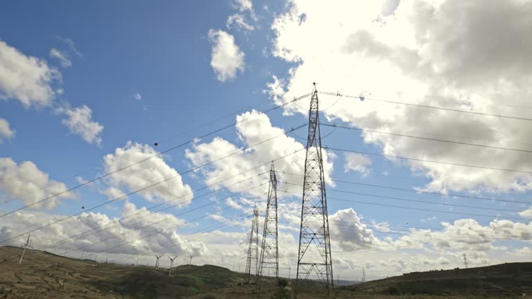 Bright clouds enveloping electrical towers.