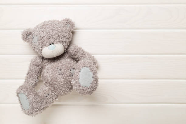 istock Cute teddy bear on wooden background, top view 1795382894