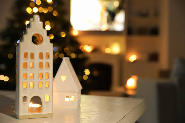 istock Beautiful house shaped candle holders on table indoors, space for text. Bokeh effect 1795390726