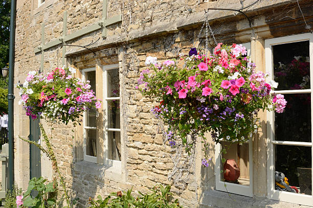 istock Cottage with hanging flower baskets. Wiltshire. England 179539100