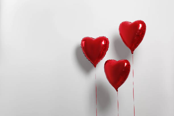 istock Many red heart shaped balloons on white background, space for text 1795392913