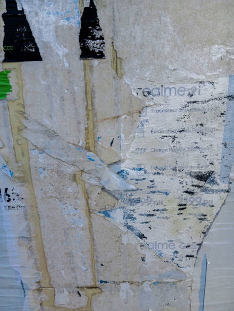 istock Weathered and torn ads poster glued to cement wall. Abstract grunge background. 1795393506