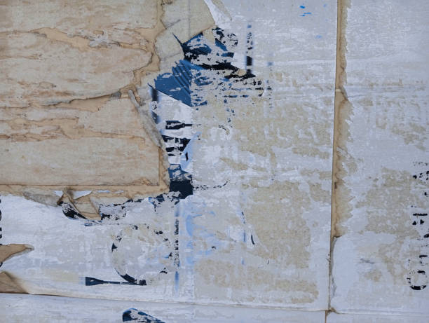 istock Weathered and torn ads poster glued to cement wall. Abstract grunge background. 1795394044