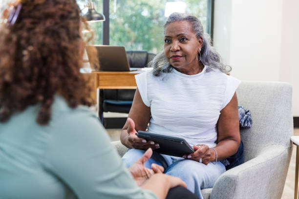 istock Mature female physician uses the digital tablet during their appointment 1795394656