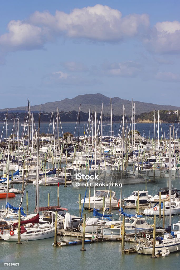 Westhaven Marina Various boats docked at Westhaven Marina, Auckland, New Zealand, the biggest marina in the southern hemisphere. Rangitoto Island is looming in the background. Large Group Of Objects Stock Photo