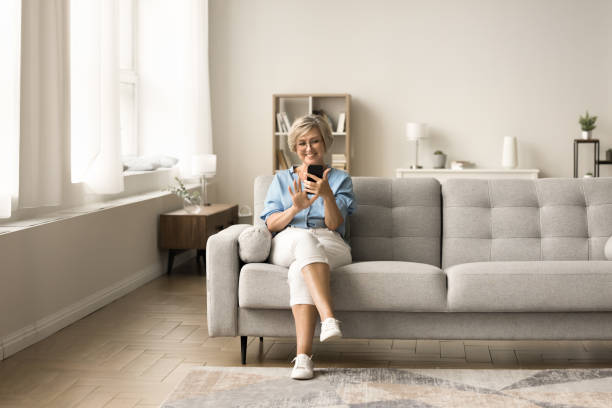 istock Happy elegant senior woman using online application on mobile phone 1795398938