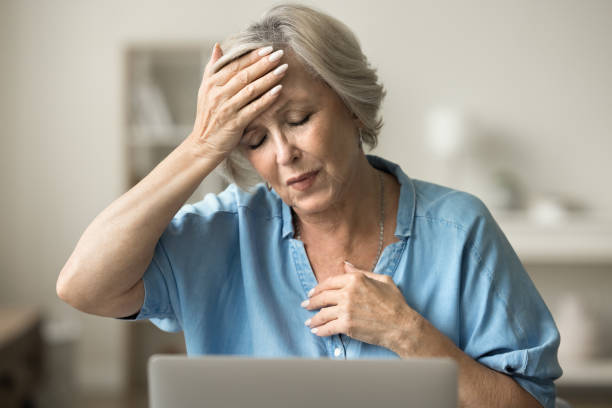 istock Sick upset elderly woman touching head and chest, feeling headache 1795406098