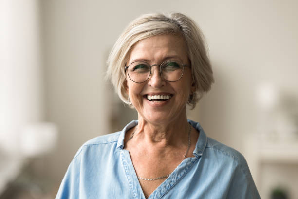 istock Cheerful pretty elder woman in elegant glasses looking at camera 1795406620