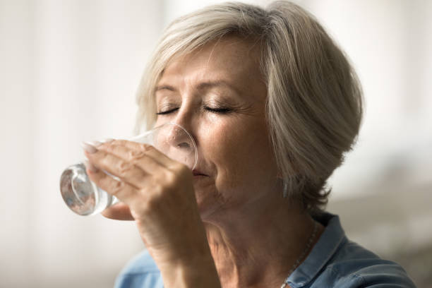istock Relaxed calm elder retired woman drinking natural fresh water 1795407684