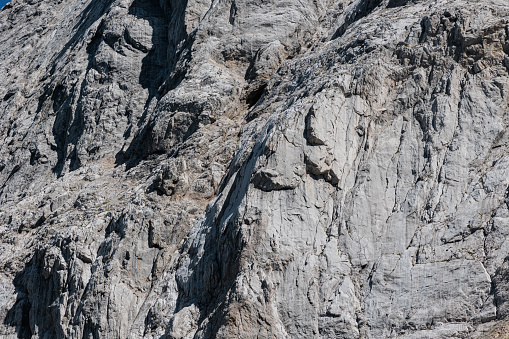 One man, male rock climber is climbing on rocks in nature.