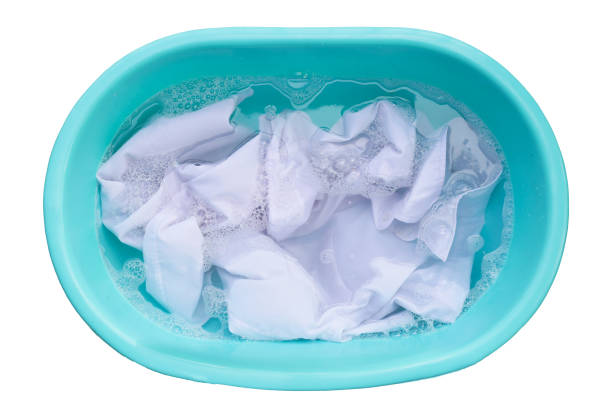 istock Laundry concept, white shirt soaking in water with detergent water dissolution, washing cloth in basin 1795412892