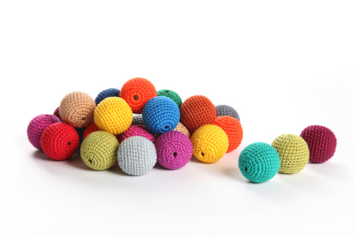 Pile of large crochet beads on white