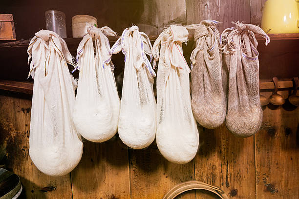 Fresh cheese curd hanging in cloth